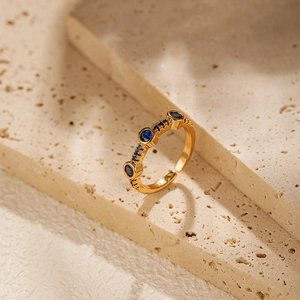 Detailed macro view of 18K gold plated ring with blue stones and vintage engraving