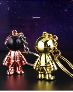 Close-up of rose gold and gold astronaut keychains with custom laser engraving service