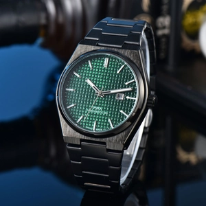 Detailed close-up of the black metal case and green waffle dial with date on this quartz watch