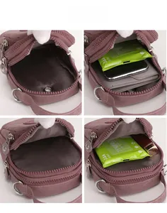 Detailed view of the purple nylon mini bag showing multi-layer interior compartments and zippers