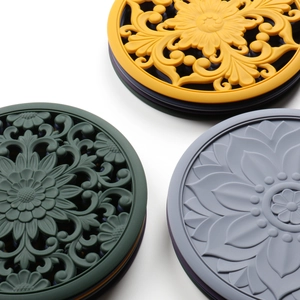 Detailed relief flower patterns on round silicone heat-resistant placemats in three colors