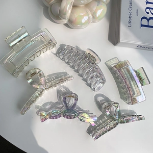 Macro shot of iridescent laser hair claws in diverse shapes with sunlight shadow effects