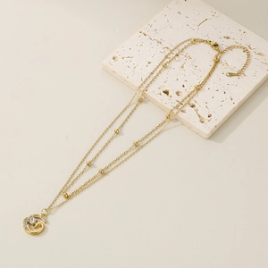 Double-layered 18K gold plated necklace with star beads and crystal spiral pendant