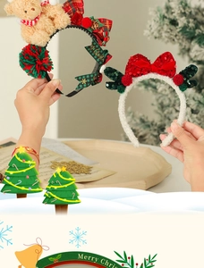 Close-up of Christmas headbands with plush bear, sequins, and merry festive decorations