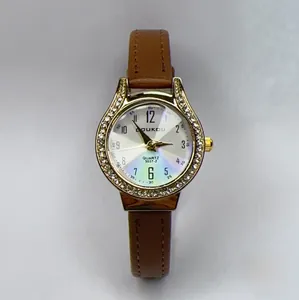 Close-up of women's quartz watch with brown leather strap and rhinestone bezel
