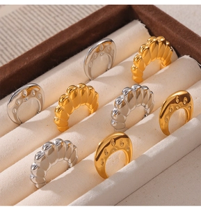 U-shaped gold and silver earrings with pleated and smooth finishes in a display box