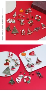 Detailed close-up of Christmas enamel brooches featuring Santa, trees, and bells
