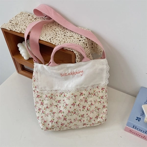 Detailed close-up of floral canvas bag with lace trim and elegant embroidery detail