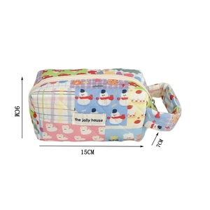 Detail of cute patchwork quilted bag with snowman and rabbit prints showing 15x9x7cm size