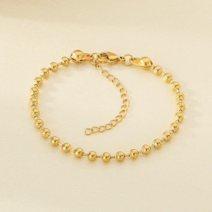 Detail of 18K gold plated beaded chain bracelet with adjustable extender and lobster clasp