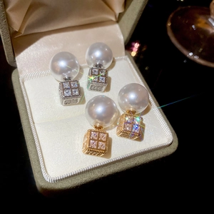 Detail of luxury square zircon and pearl earrings in gold and silver finish