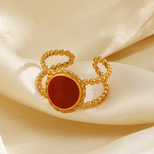 18K gold plated stainless steel ring with red enamel oval, showcased on beige silk
