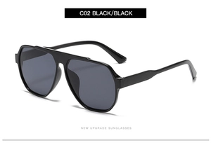 Detail view of stylish oversized pilot sunglasses with sleek black frame and dark lenses
