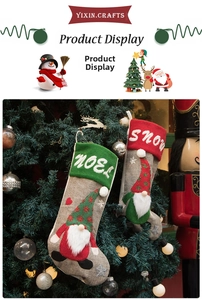 Detail of red and green gnome Christmas stockings with embroidered NOEL and SNOW lettering