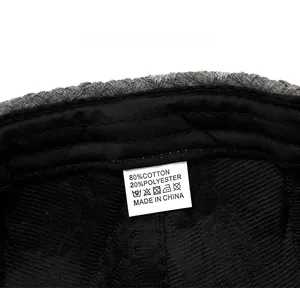 Care label detail of knitted beret showing 80% cotton and 20% polyester material blend
