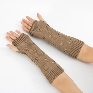 Detail of coffee brown long knitted arm warmers with heart-shaped cutout and ribbed cuffs
