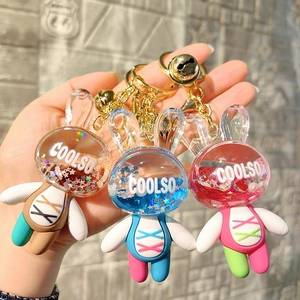 Three cute acrylic liquid sand rabbit keychains with gold rings and colorful bells