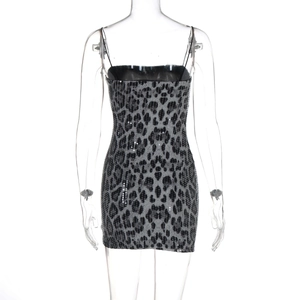 Close-up of leopard print sequin fabric and thin straps on a bodycon mini dress