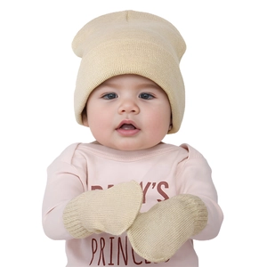 Detailed close-up of beige knit baby hat and matching mittens on a white background