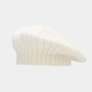 Detail of cream white knit beret showing chunky vertical ribbing and soft wool texture
