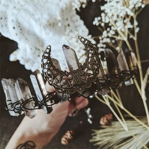 Detail of handmade bohemian quartz crystal crown with a bronze crescent moon center