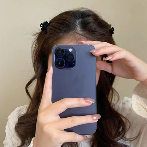 Close-up of a small black velvet bow hair claw clip styled on a model's hair