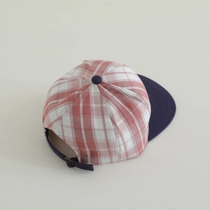 Detail of red and white plaid pattern and adjustable strap on a vintage kids flat brim hat