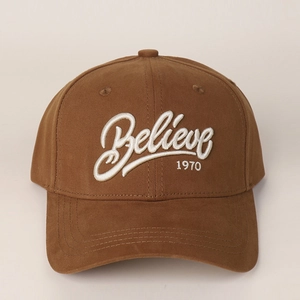 Close-up of white 3D embroidery Believe 1970 on coffee brown cotton baseball cap