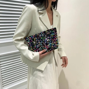 Fashionable sequin clutch bag with colorful scales shown with elegant outfit