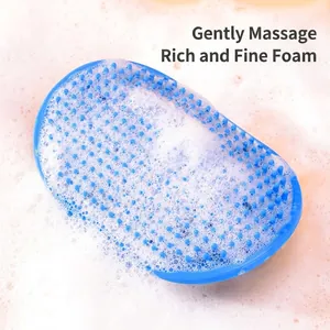 Blue silicone pet bath massage brush creating rich white foam for dogs and cats