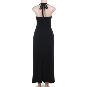 Detail view of black backless maxi dress with halter neck and slim fit on a mannequin