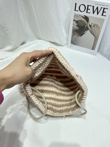 Close-up of knit cat ear beanie showing thick striped texture and soft drawstring detail