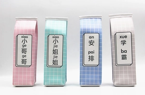 Row of colorful milk box pencil cases in pink, green, blue and grey leather finishes