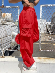 Retro loose red cargo pants with elastic waist and large side flap pockets for women