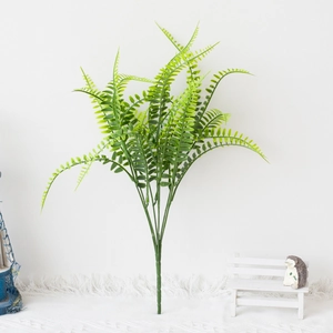 Detail of artificial green fern leaves with realistic textures for indoor and outdoor decor