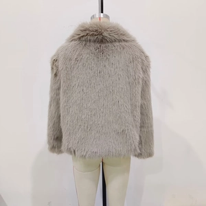 Detail view of the faux fur jacket back design with a wide collar and short cut