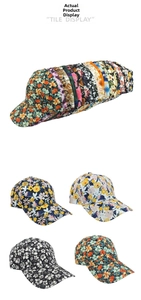 Flat display of various floral and tropical print baseball caps with curved brims
