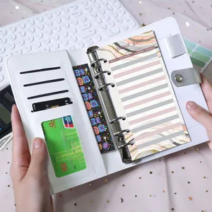 Macro detail of A6 white PU leather binder with 6-ring binder and budget sheet inside