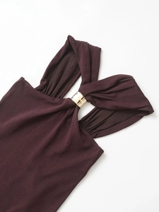 Detailed macro view of deep brown ribbed knit fabric with gold metal ring decoration