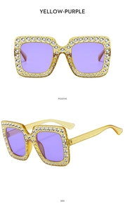 Detail view of square rhinestone sunglasses with yellow frame and purple lenses