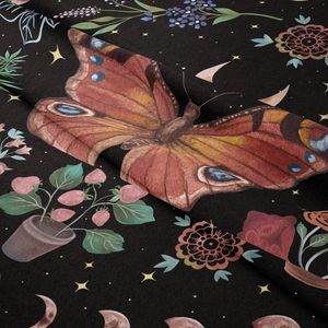 Detail of soft black flannel tapestry with butterfly moon phase and floral pattern print