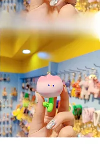 Detailed close-up of a cute cartoon resin tulip keychain with a pink gradient finish