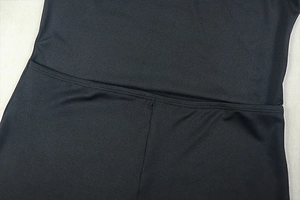 Close-up of durable double stitching and smooth black fabric on an elegant backless dress