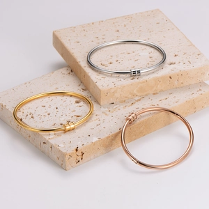Three-color stainless steel bangles in gold, silver, and rose gold with zircon accents