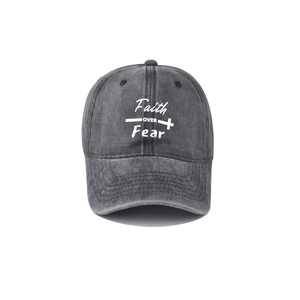 Detail of washed dark gray denim baseball cap with Faith OVER Fear text and cross