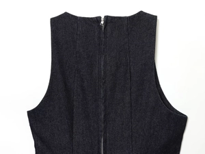 Detail of dark denim short dress with visible fabric texture and back metal zipper