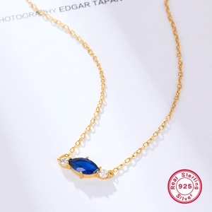 Close-up of S925 sterling silver necklace featuring a blue marquise-cut zircon pendant