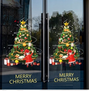 Close-up of Merry Christmas window stickers featuring Santa Claus and decorated trees