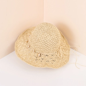 Wide brim raffia sun hat with shell accents for summer beach vacation style