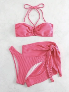Flat lay of hot pink ribbed bikini set with matching mesh tie-side sarong skirt